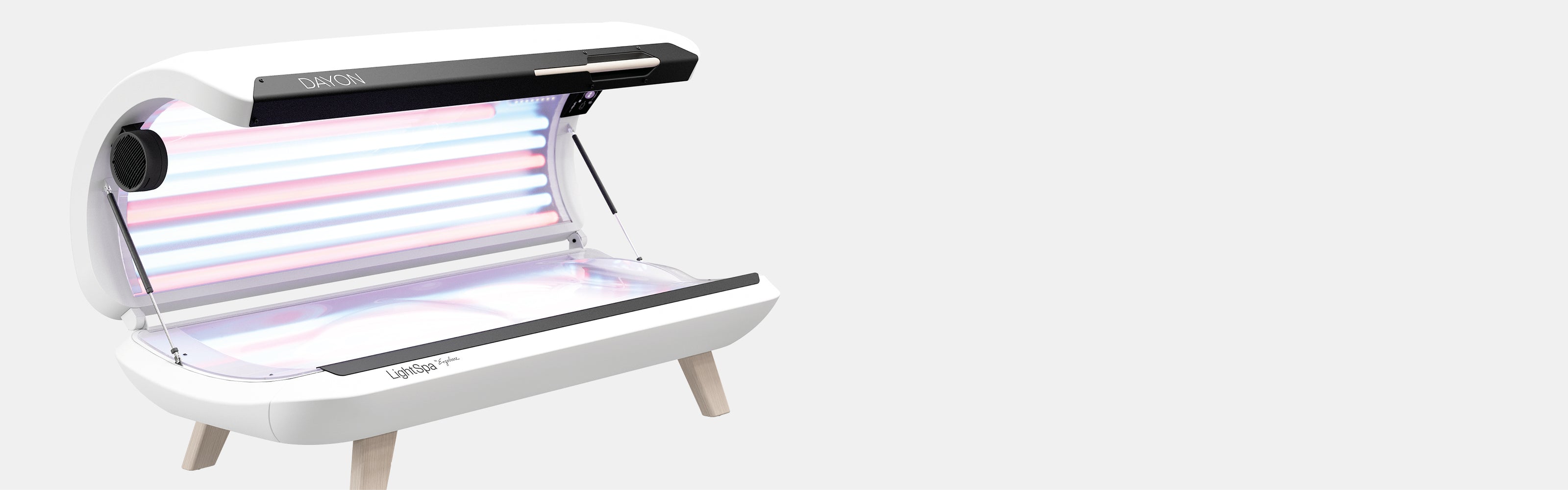 DAYON LightSpa Hybrid UV-Heimsolarium mit weißem Hintergrund, dass aufgeklappt ist, sodass man sowohl die blauen Solarium-Röhren des Deckels als auch die Liegefläche sehen kann